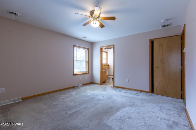 spare room featuring a ceiling fan, visible vents, light carpet, and baseboards