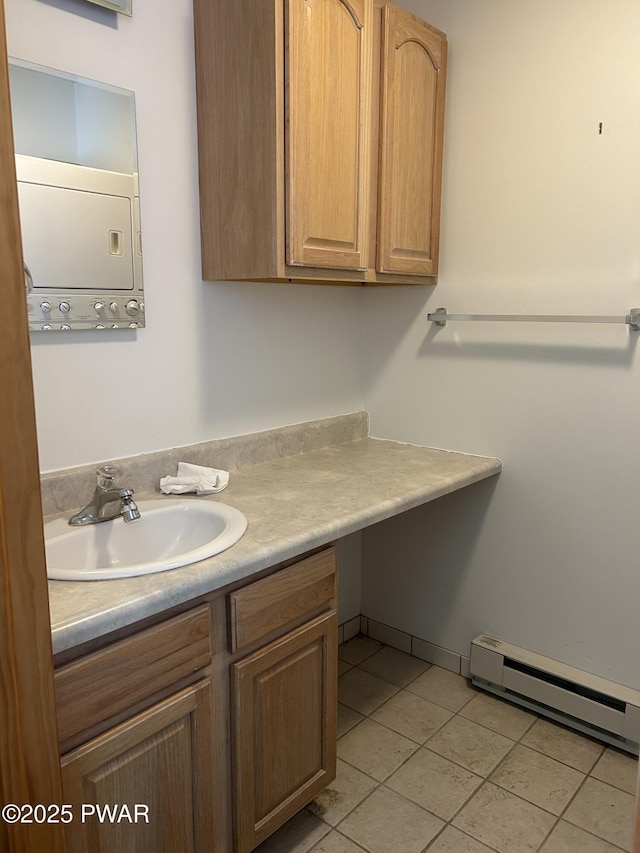 bathroom with a baseboard radiator, vanity, and tile patterned floors