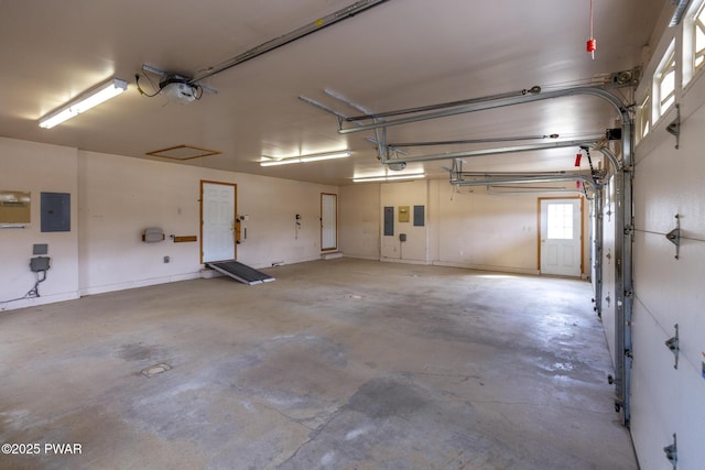 garage featuring electric panel and a garage door opener