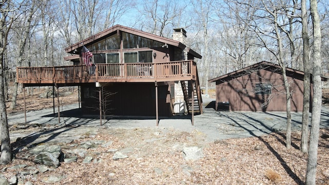 802 Rimrock Ct, Lords Valley, PA 18428 - back of property featuring a chimney, an outdoor structure, a deck, and stairway