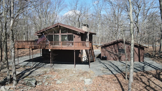 802 Rimrock Ct, Lords Valley, PA 18428 - back of house featuring a wooden deck, a chimney, stairway, an outbuilding, and a shed