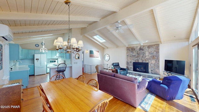802 Rimrock Ct, Lords Valley, PA 18428 - dining room with a wall unit AC, ceiling fan with notable chandelier, light wood-style flooring, a stone fireplace, and vaulted ceiling with beams