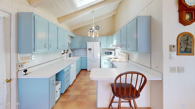 802 Rimrock Ct, Lords Valley, PA 18428 - kitchen with light countertops, vaulted ceiling with skylight, blue cabinets, a peninsula, and white appliances
