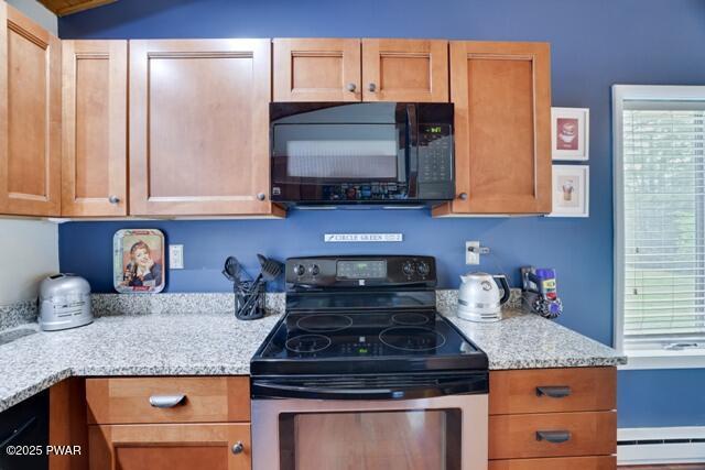 802 Forest Cir Unit 802, Paupack, PA 18464 - kitchen featuring black microwave, stainless steel electric range oven, baseboard heating, and healthy amount of natural light