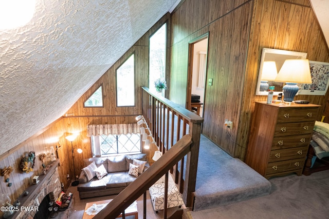 28 Lakewood Dr, Lake Ariel, PA 18436 - bedroom featuring wood walls, carpet, lofted ceiling, and a textured ceiling
