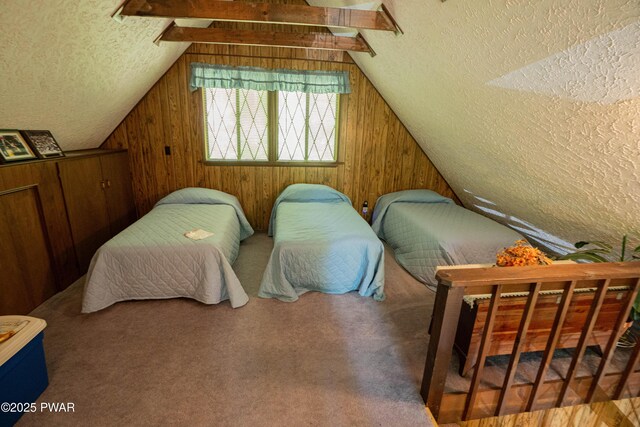 28 Lakewood Dr, Lake Ariel, PA 18436 - carpeted bedroom with a textured ceiling, wooden walls, and vaulted ceiling