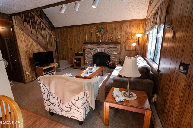 28 Lakewood Dr, Lake Ariel, PA 18436 - living room featuring a textured ceiling, wooden walls, stairway, lofted ceiling, and a fireplace