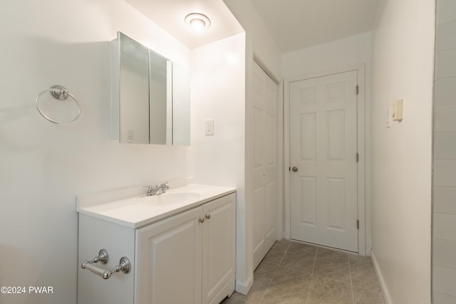 bathroom with tile patterned flooring and vanity