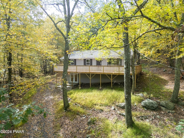 rear view of house featuring a wooden deck