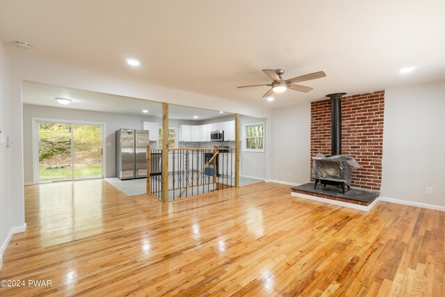 unfurnished living room featuring light hardwood / wood-style floors, plenty of natural light, and ceiling fan