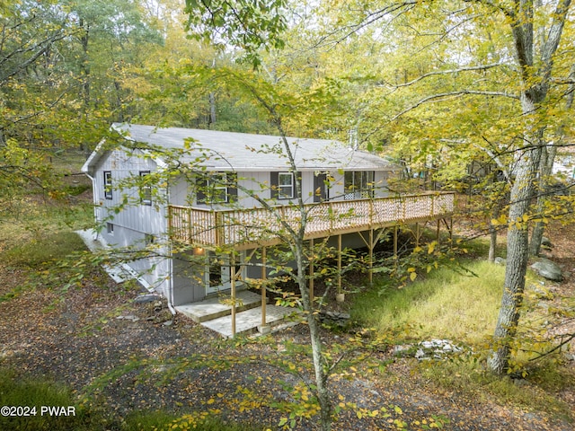 back of house featuring a deck