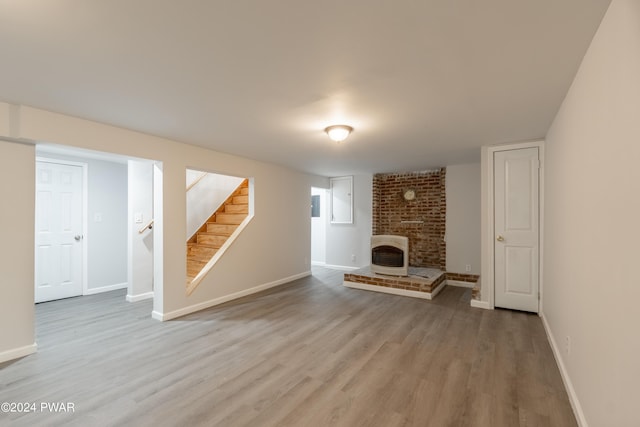 unfurnished living room with a fireplace and light hardwood / wood-style flooring