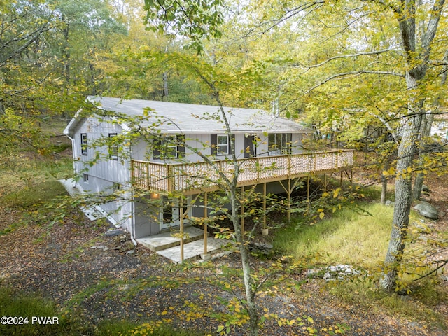 rear view of property with a wooden deck