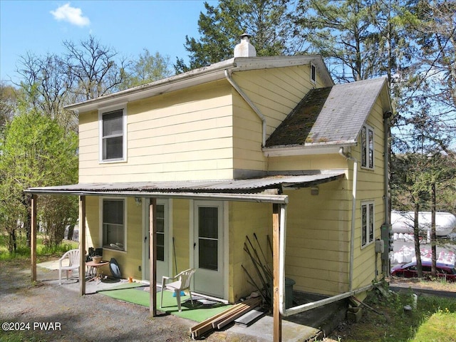 back of property with a patio