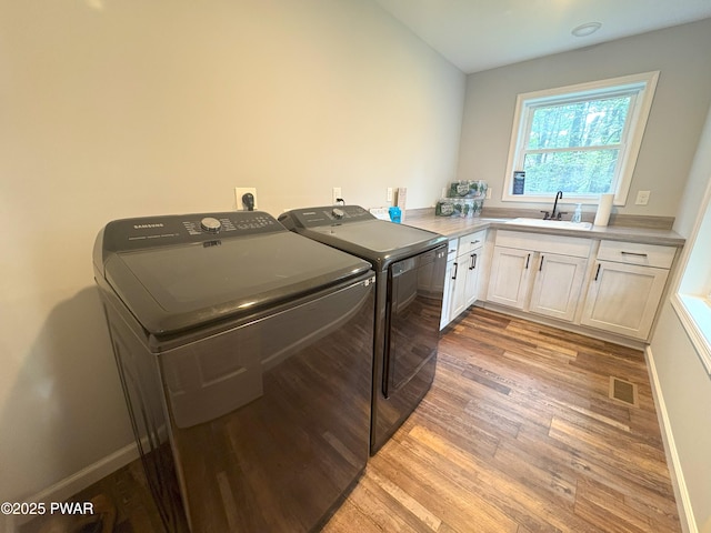 1006 Redlawn Ln, Lake Ariel, PA 18436 - washroom featuring washer and dryer, cabinet space, and light wood-type flooring
