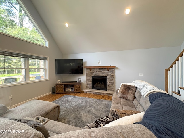 1006 Redlawn Ln, Lake Ariel, PA 18436 - living area featuring wood finished floors, high vaulted ceiling, a fireplace, and stairs