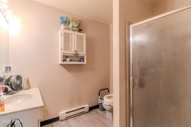53 Windsor Rd, Hawley, PA 18428 - bathroom featuring a baseboard radiator, vanity, a shower stall, and wood finished floors