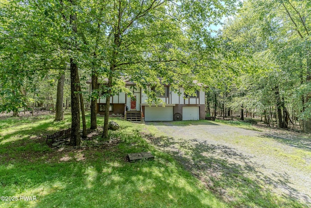 53 Windsor Rd, Hawley, PA 18428 - bi-level home with an attached garage, stucco siding, and gravel driveway