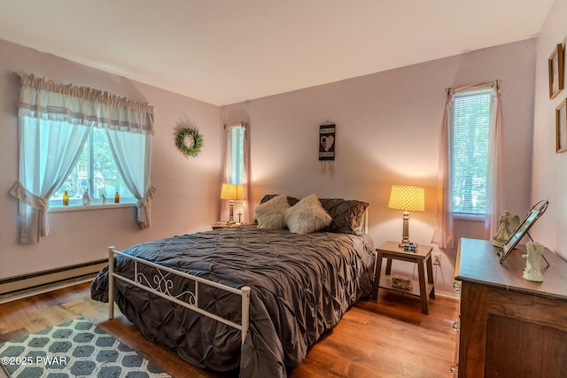 53 Windsor Rd, Hawley, PA 18428 - bedroom featuring multiple windows, wood finished floors, and baseboard heating