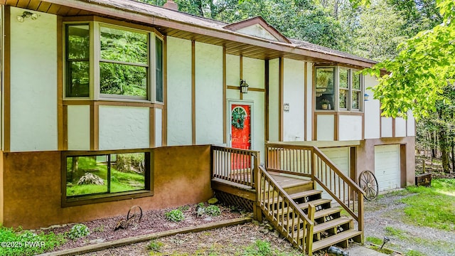 53 Windsor Rd, Hawley, PA 18428 - view of front of home featuring stucco siding, an attached garage, and driveway