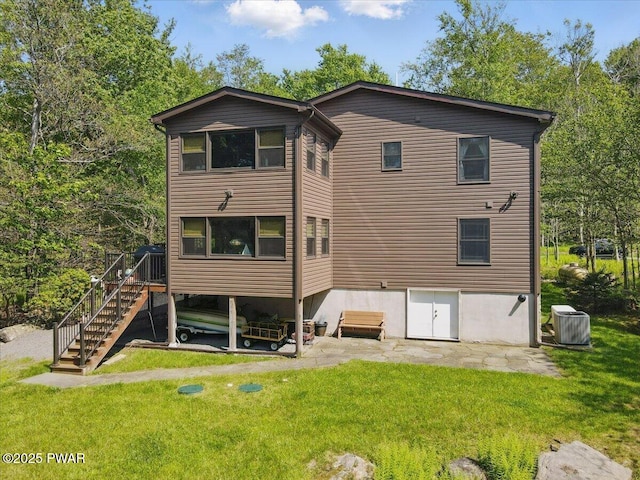1057 K Ln, Gouldsboro, PA 18424 - back of house with a yard, central AC unit, stairway, and a patio