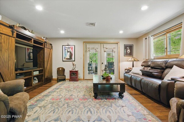 1057 K Ln, Gouldsboro, PA 18424 - living area with a barn door, plenty of natural light, wood finished floors, and recessed lighting