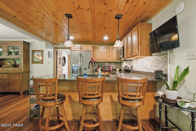 1057 K Ln, Gouldsboro, PA 18424 - kitchen with appliances with stainless steel finishes, wooden ceiling, a peninsula, backsplash, and pendant lighting