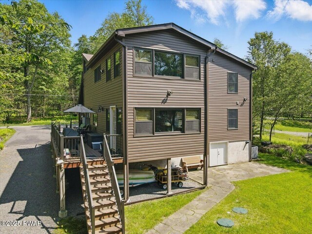 1057 K Ln, Gouldsboro, PA 18424 - back of house featuring a yard, a deck, and a patio