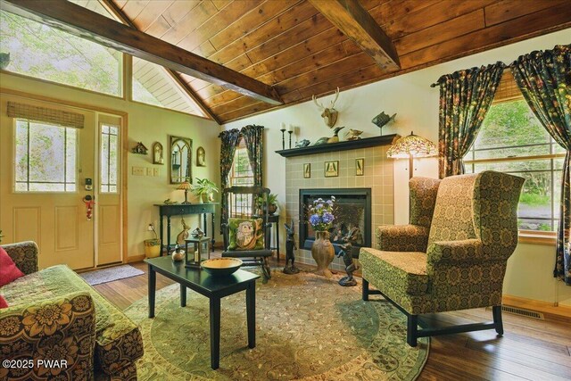 1057 K Ln, Gouldsboro, PA 18424 - living area featuring wood finished floors, a tiled fireplace, wooden ceiling, and baseboards