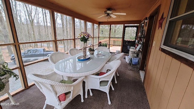 sunroom / solarium featuring ceiling fan