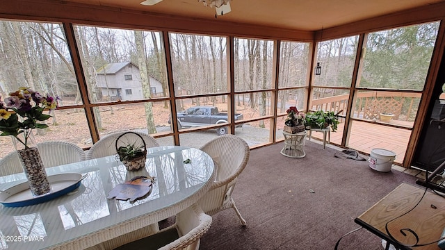 sunroom / solarium featuring ceiling fan