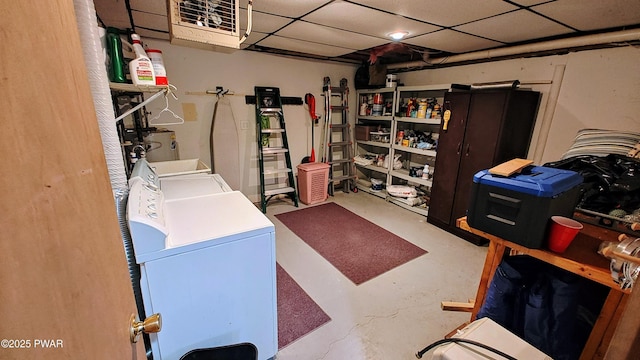 finished basement with a paneled ceiling and a heating unit