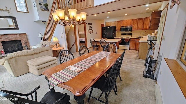 dining room with stairs, recessed lighting, a fireplace, and a chandelier