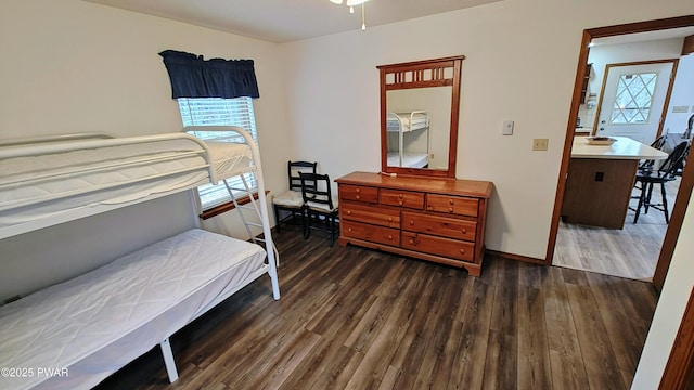 bedroom featuring baseboards and wood finished floors