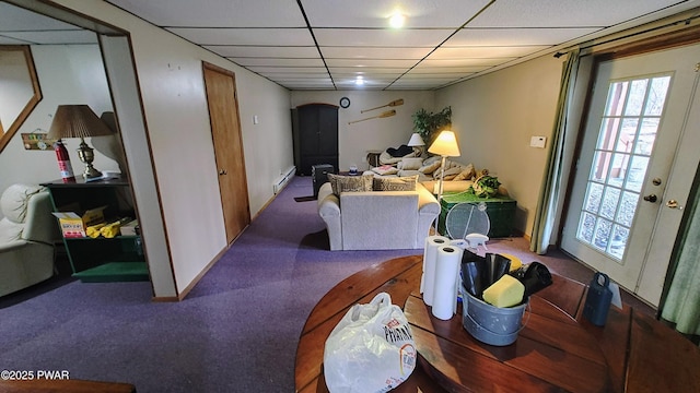 dining area with a paneled ceiling and baseboard heating