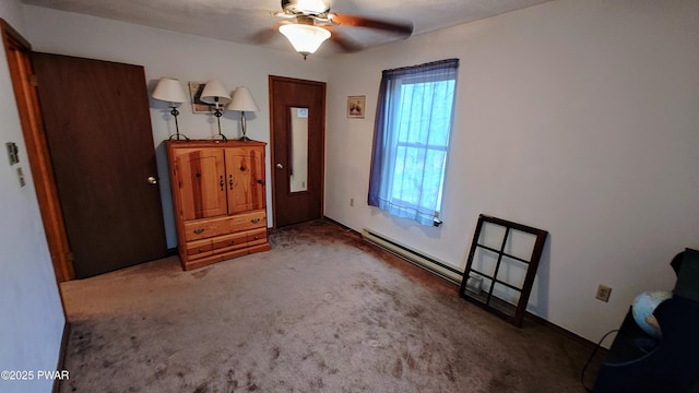 carpeted entrance foyer featuring baseboard heating and a ceiling fan