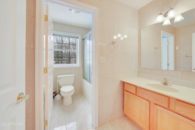 129 Lakewood Dr, Dingmans Ferry, PA 18328 - bathroom with tile walls, tile patterned flooring, vanity, bath / shower combo with glass door, and a chandelier