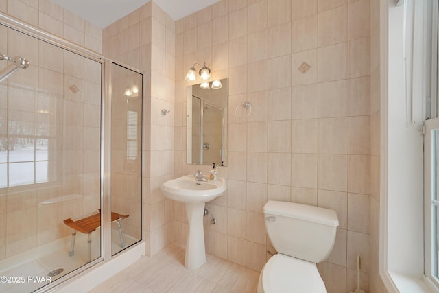 129 Lakewood Dr, Dingmans Ferry, PA 18328 - full bathroom with tile walls, a shower stall, and tile patterned flooring