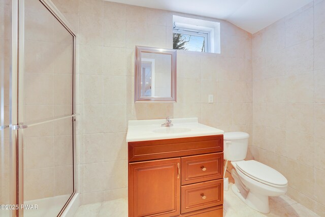 129 Lakewood Dr, Dingmans Ferry, PA 18328 - full bath with tile walls, vanity, a stall shower, tile patterned floors, and vaulted ceiling