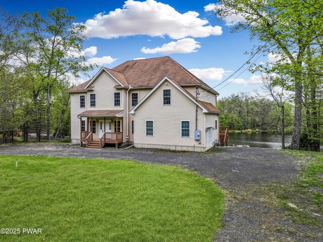 129 Lakewood Dr, Dingmans Ferry, PA 18328 - back of property with covered porch, a lawn, a water view, and driveway