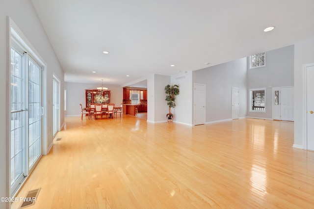 129 Lakewood Dr, Dingmans Ferry, PA 18328 - unfurnished living room with light wood-type flooring, a chandelier, and recessed lighting