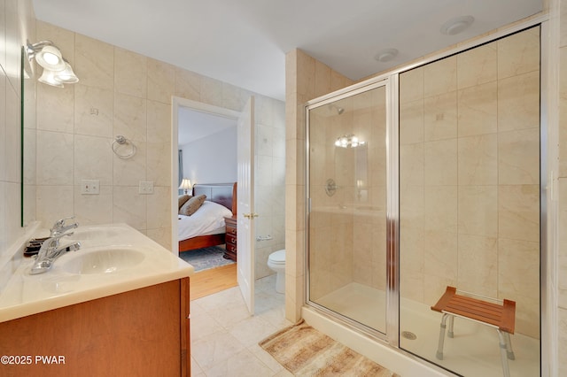129 Lakewood Dr, Dingmans Ferry, PA 18328 - full bath with tile walls, a stall shower, double vanity, and connected bathroom