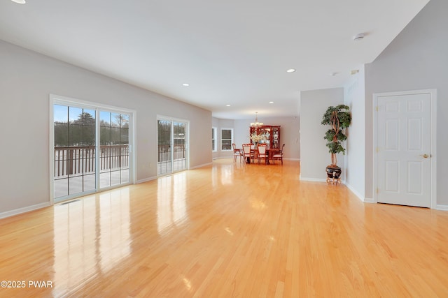 129 Lakewood Dr, Dingmans Ferry, PA 18328 - spare room featuring light wood-style flooring, a chandelier, and recessed lighting