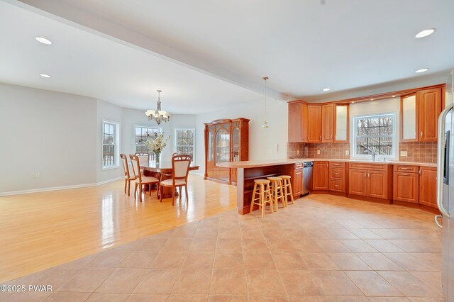 129 Lakewood Dr, Dingmans Ferry, PA 18328 - kitchen featuring appliances with stainless steel finishes, a peninsula, recessed lighting, a chandelier, and light countertops