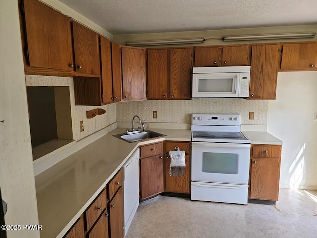 29 Burnett Way, Washingtonville, NY 10992 - kitchen with light countertops, white appliances, brown cabinets, and a sink