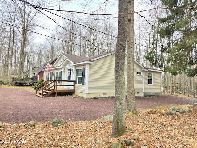 127 Maxatawny Dr, Pocono Lake, PA 18347 - manufactured / mobile home with crawl space, a wooden deck, and a shingled roof