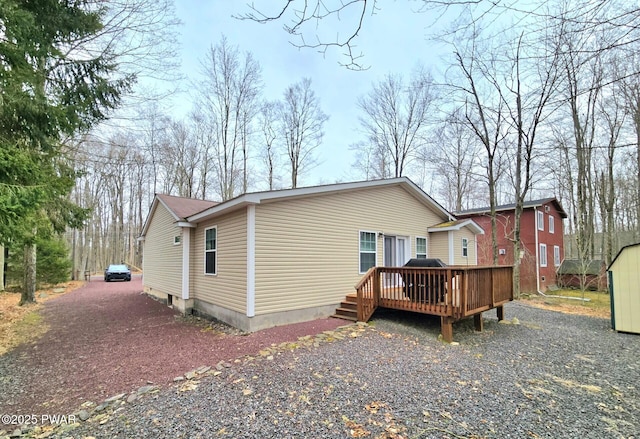 127 Maxatawny Dr, Pocono Lake, PA 18347 - rear view of property with a wooden deck and a storage unit