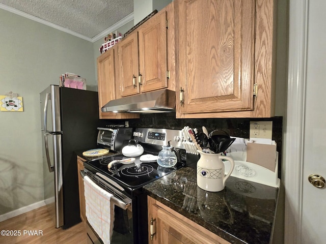 127 Maxatawny Dr, Pocono Lake, PA 18347 - kitchen with stainless steel appliances, under cabinet range hood, crown molding, a textured ceiling, and tasteful backsplash