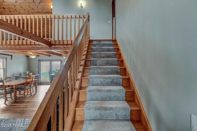 stairs featuring wood finished floors and baseboards