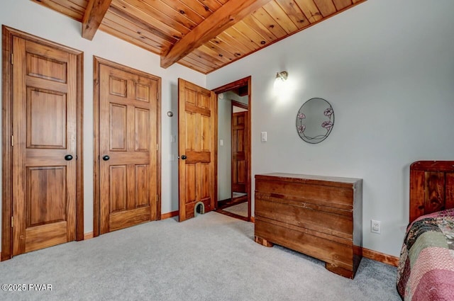 bedroom with carpet flooring, wooden ceiling, beamed ceiling, and baseboards
